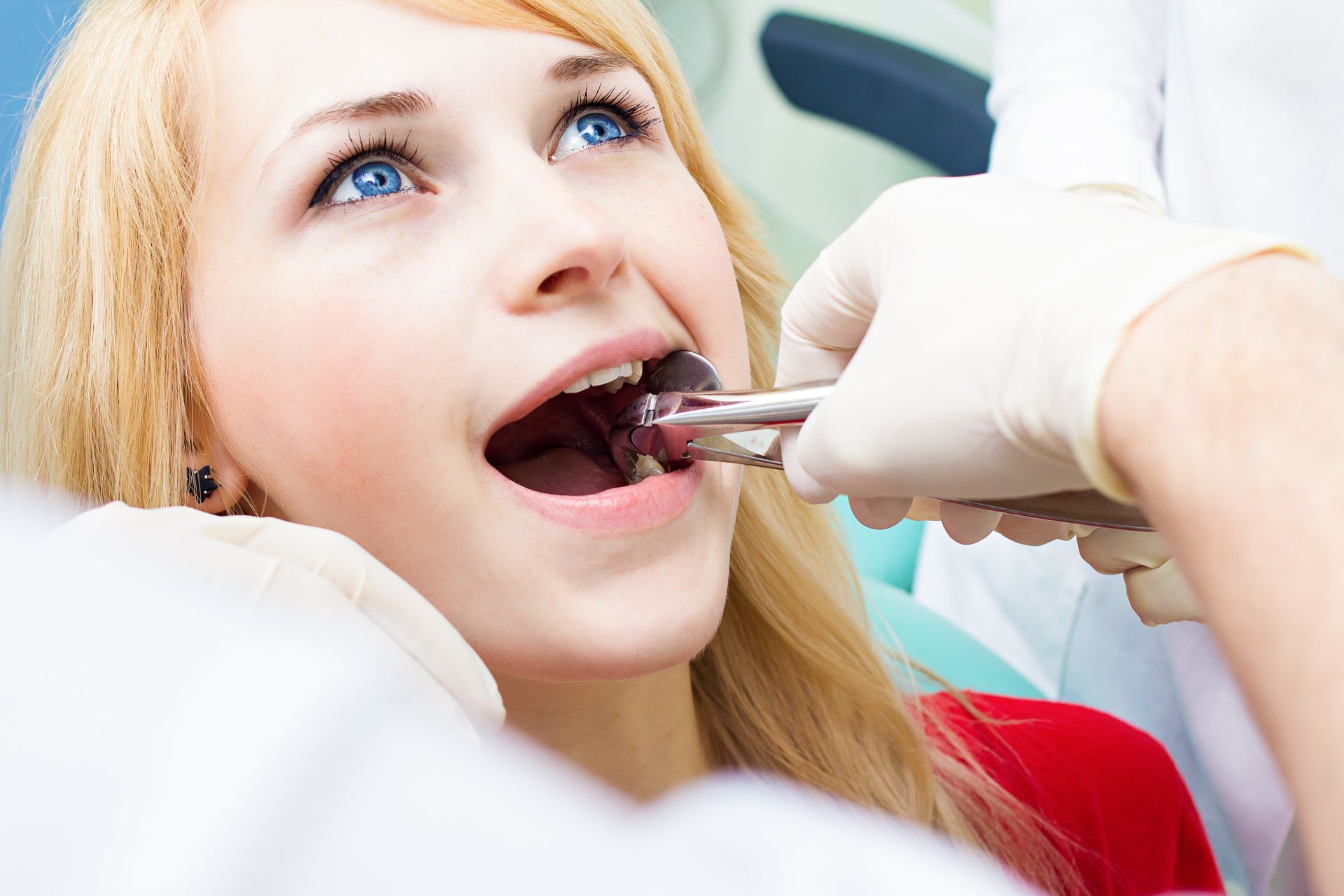 Patient undergoing a professional tooth extraction procedure at a modern dental clinic.