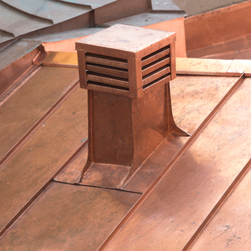 A copper chimney on top of a copper roof