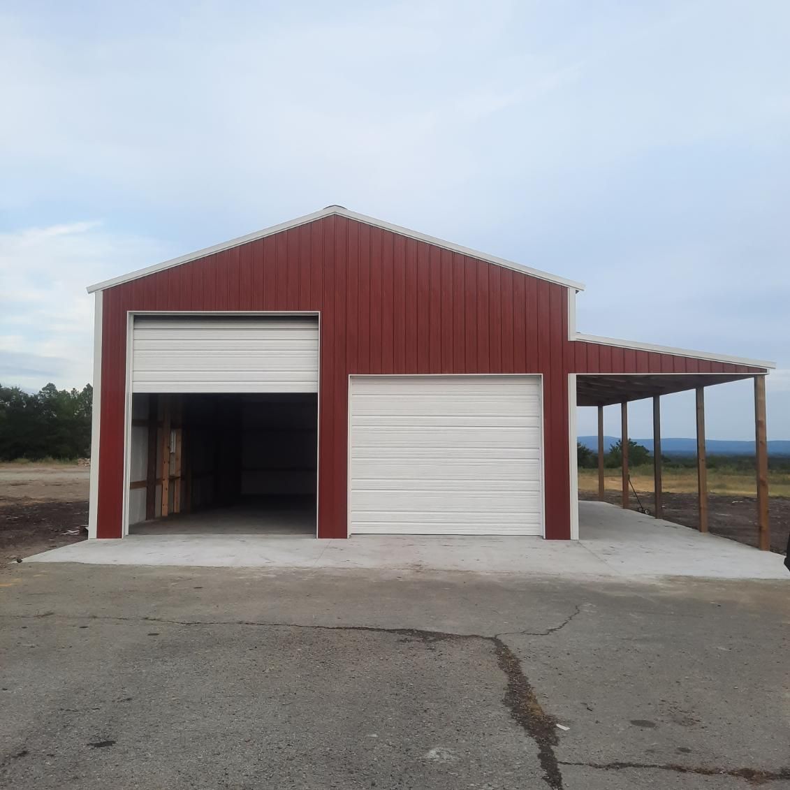 A Red and White Building With a White Garage Door