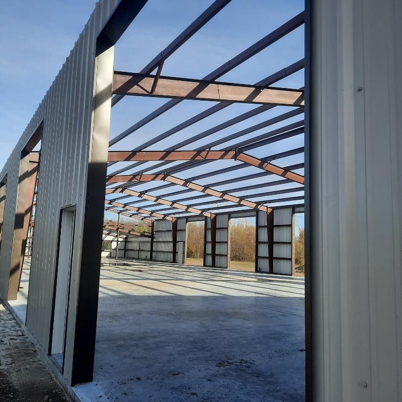 The inside of a building under construction with a blue sky in the background