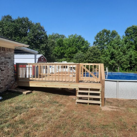 A Wooden Deck Sits Next to a Swimming Pool