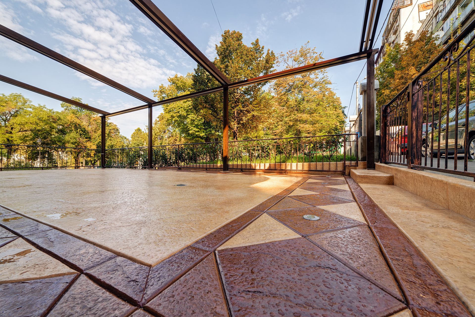 A Patio With a Fence and Trees in the Background