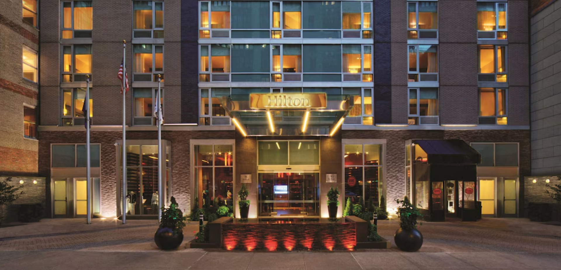 Hilton New York Fashion District exterior building facade Midtown Chelsea Manhattan renovated 2025