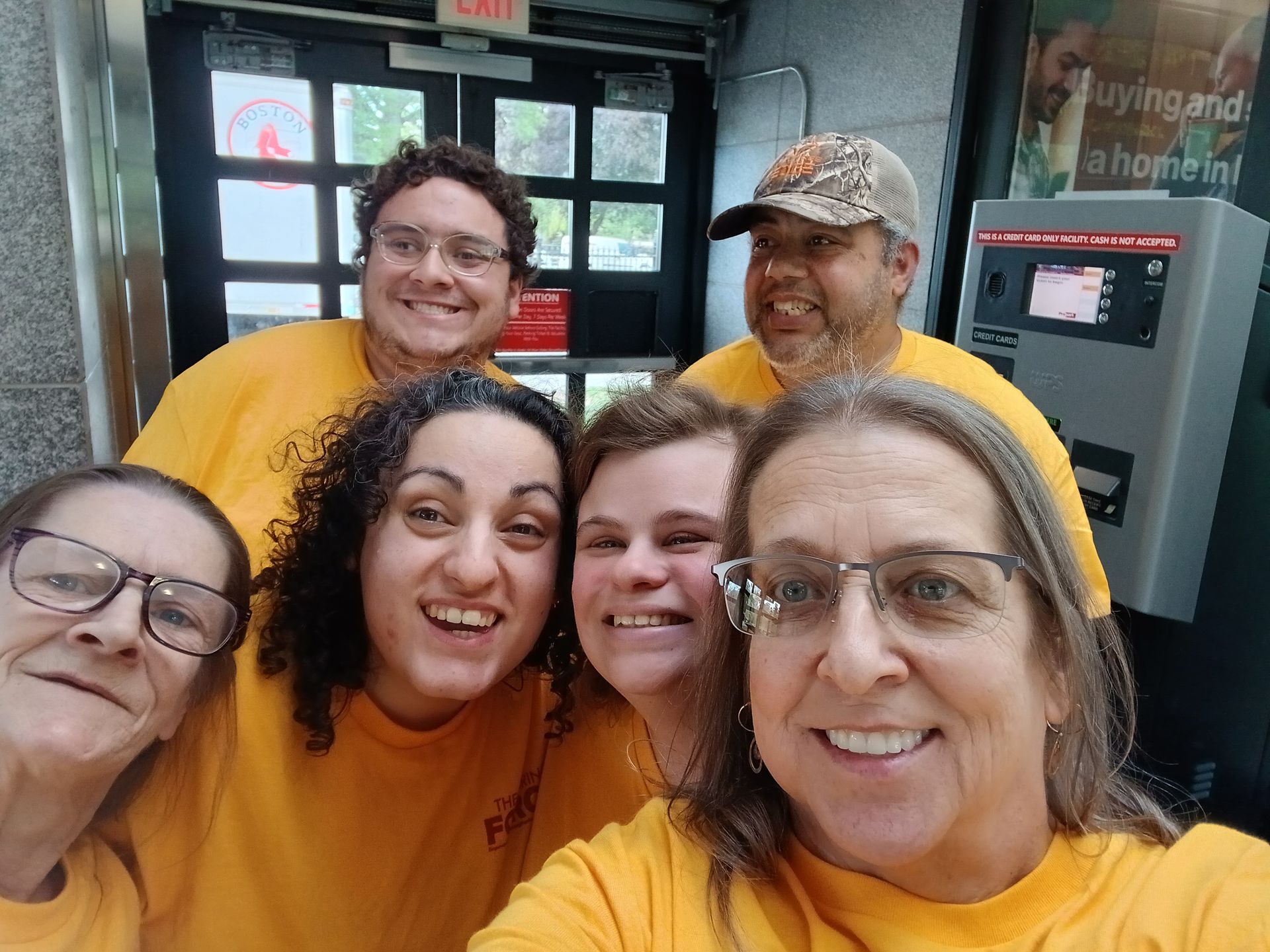 A group of BFAIR staff and individuals in yellow shirts at the Caring Force Rally in Boston