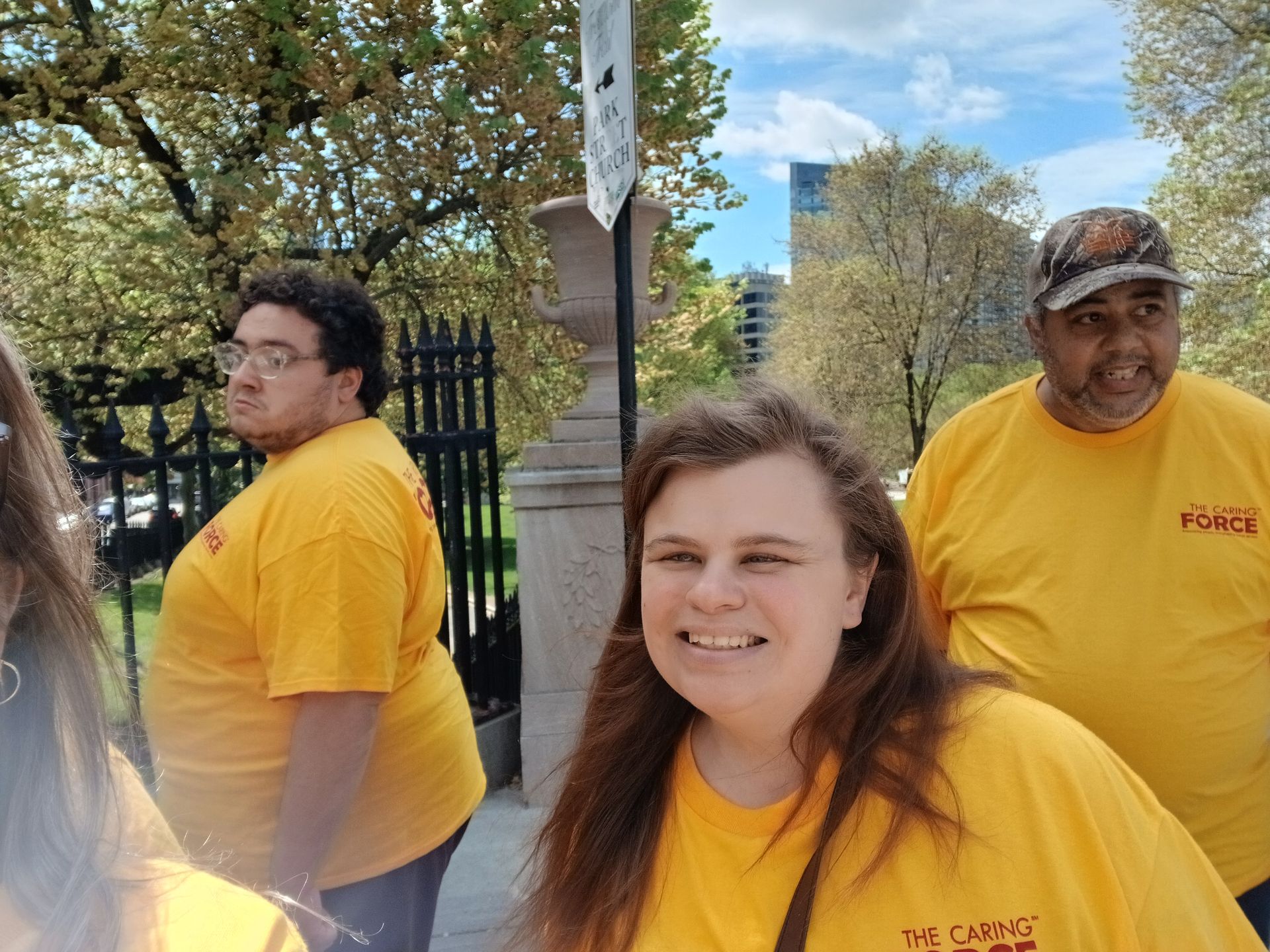 A group of BFAIR staff and individuals in yellow shirts at the Caring Force Rally in Boston