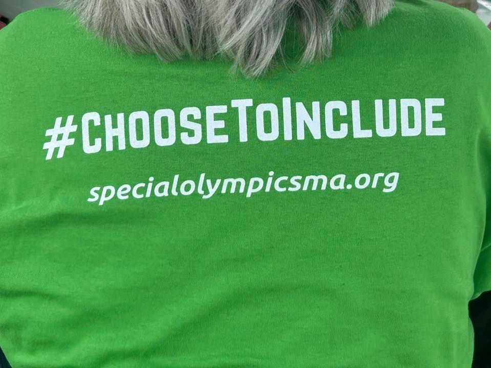 A green shirt with the #choosetoinclude hash tag for Special Olympics