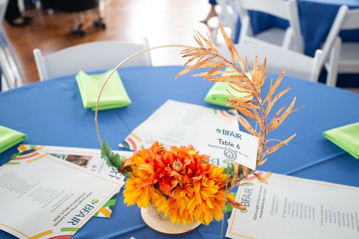A floral centerpiece on a table at the BFAIR Annual Meeting