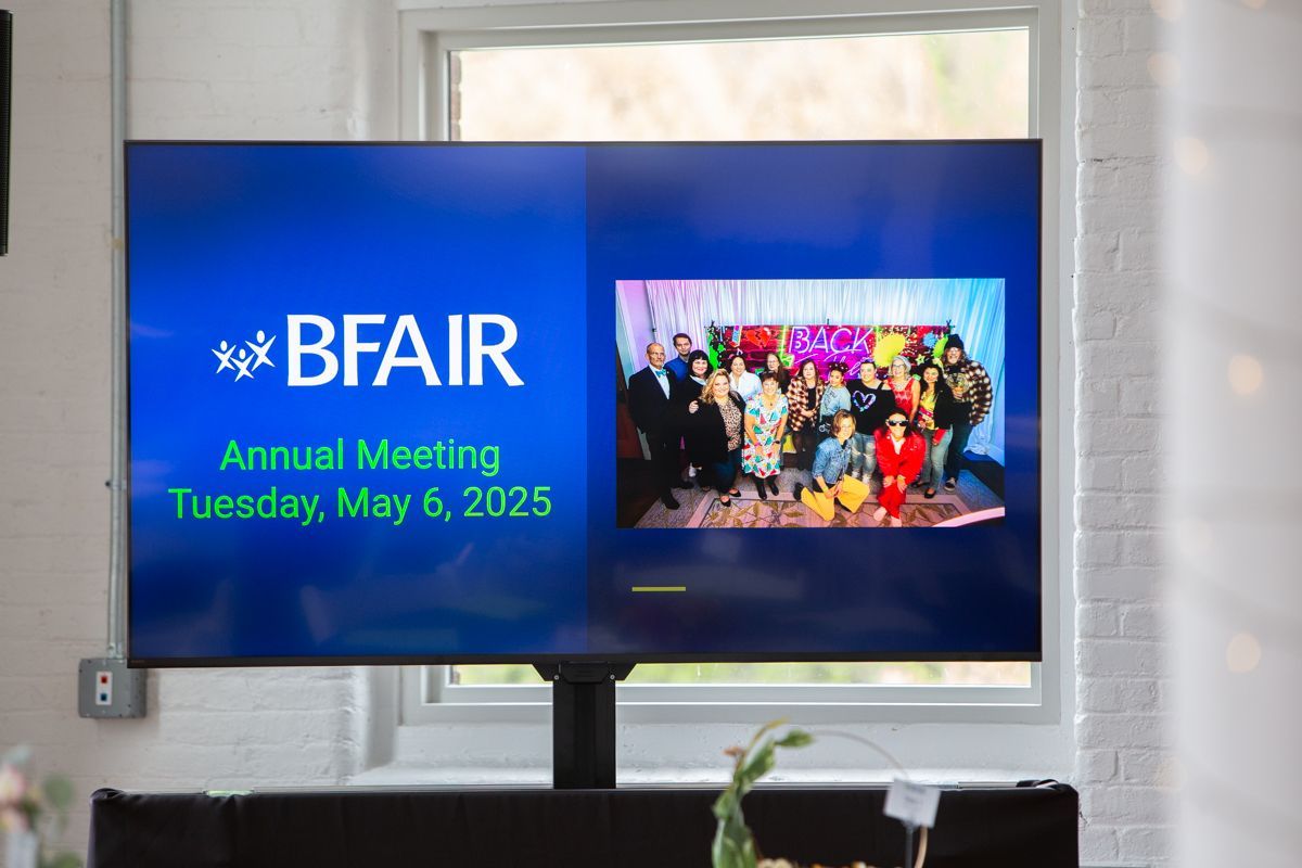 A TV screen welcoming guests to the BFAIR Annual Meeting