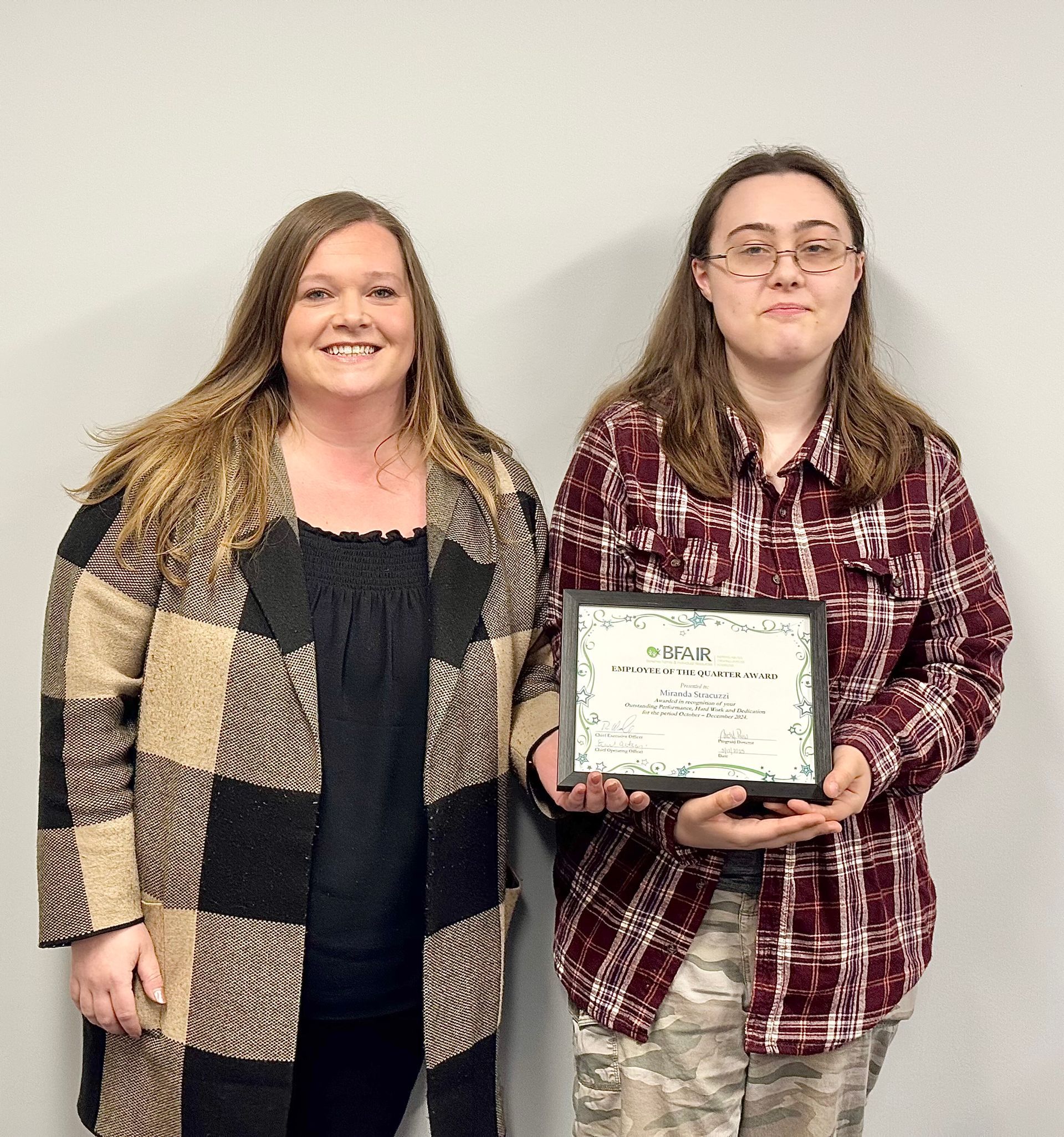 Miranda Stracuzzi holding award