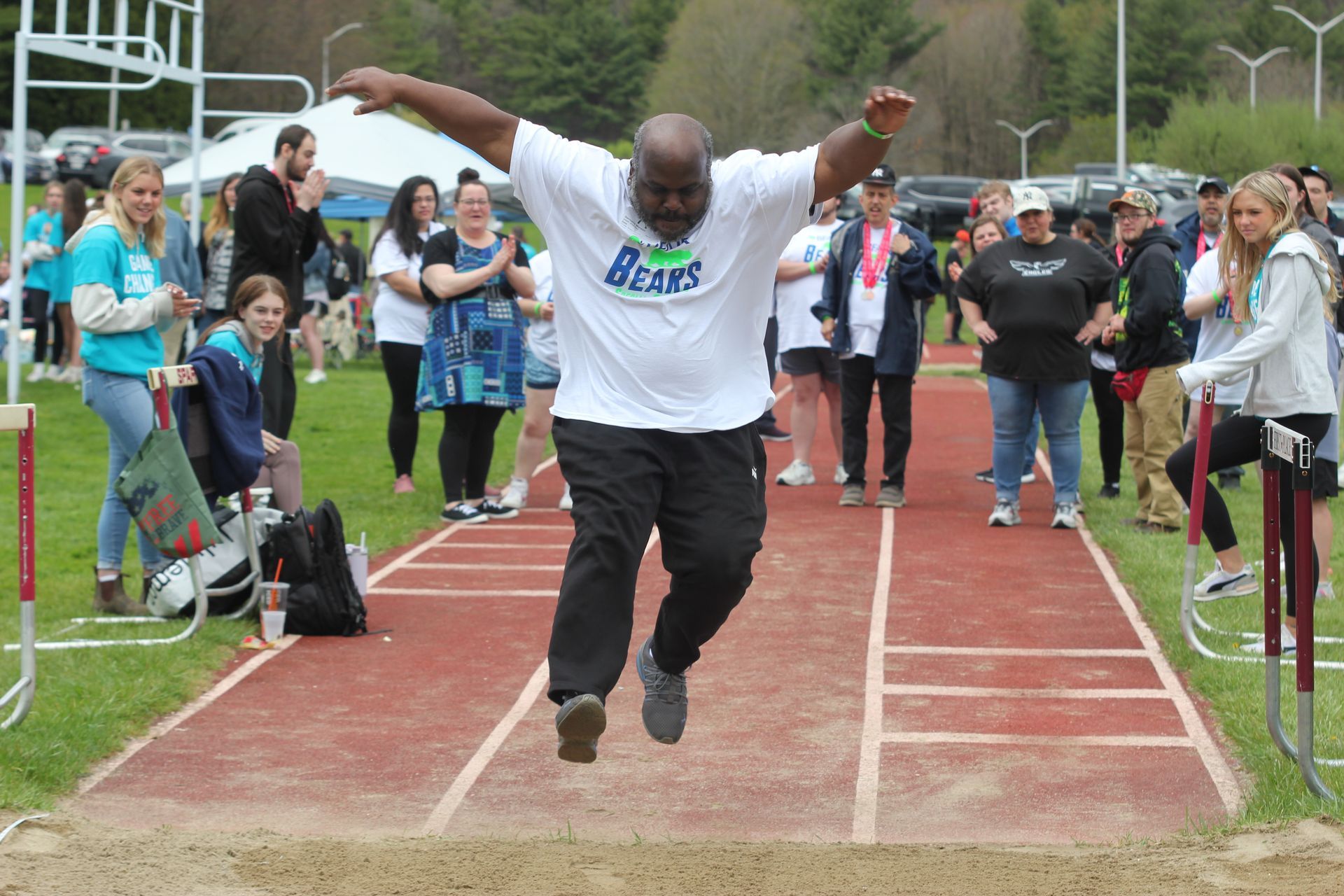 Person crossing finish line at Special Olympics