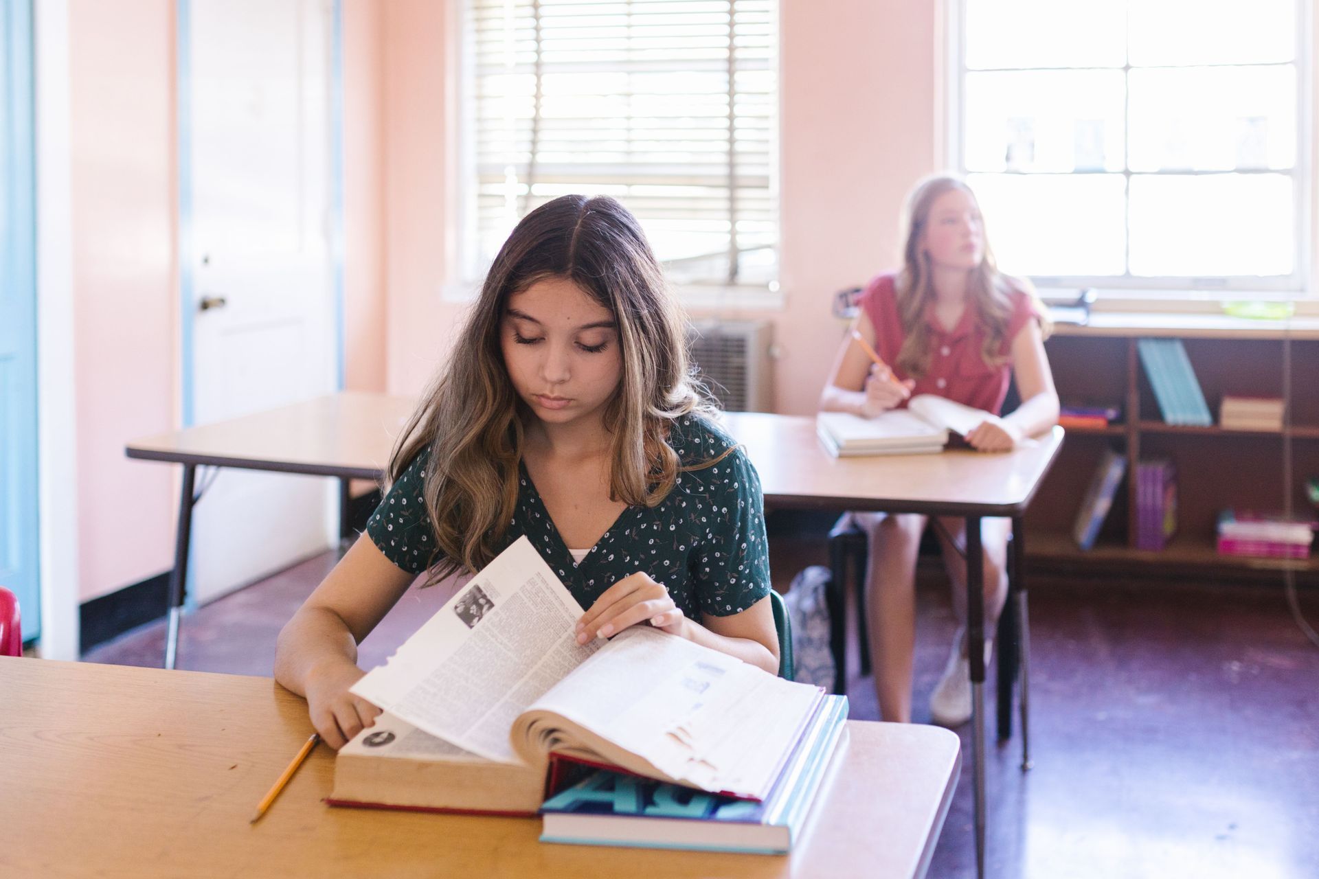 Two female students in a classroom