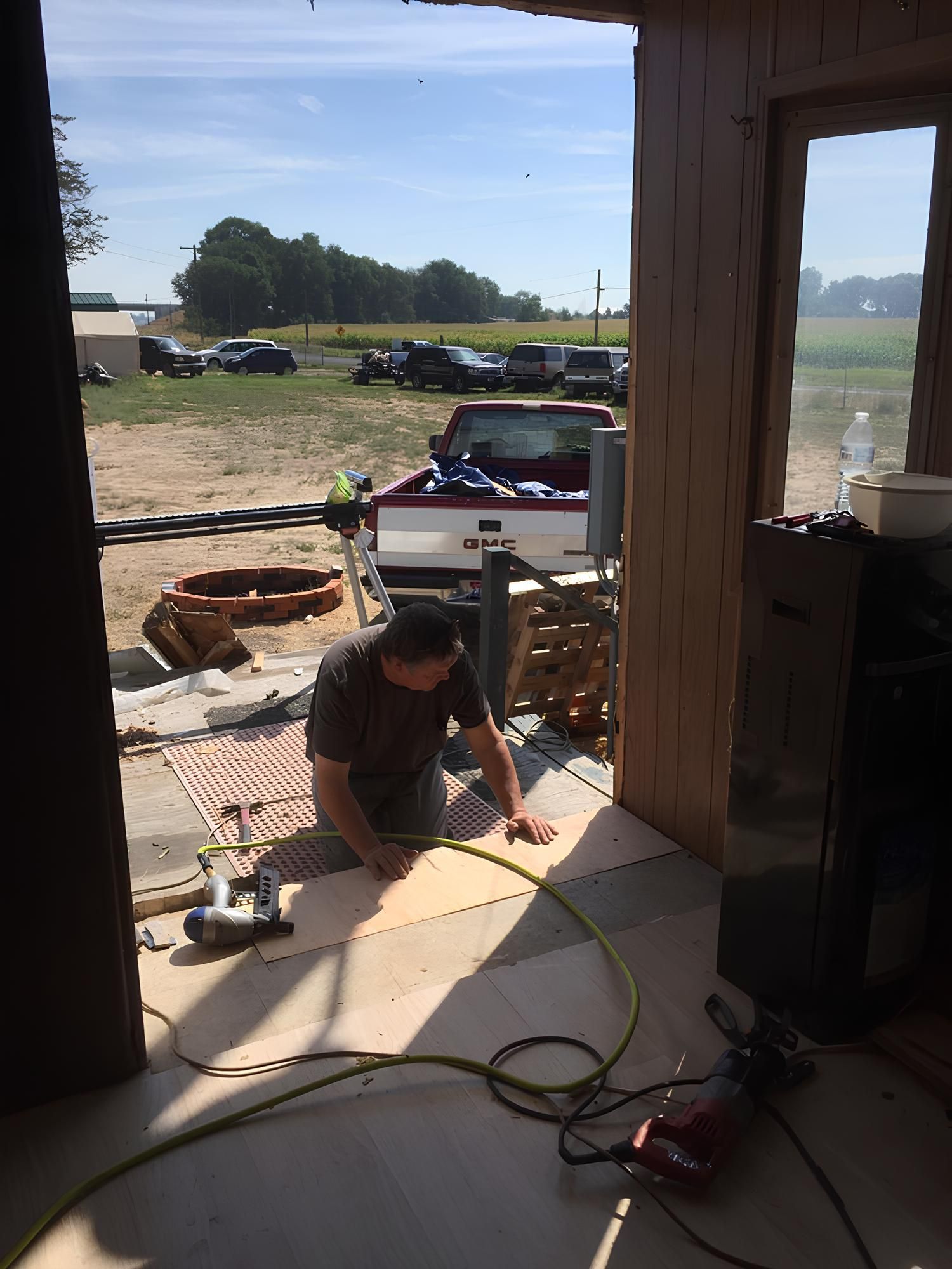 HVAC technician working on an air conditioning unit outdoors.
