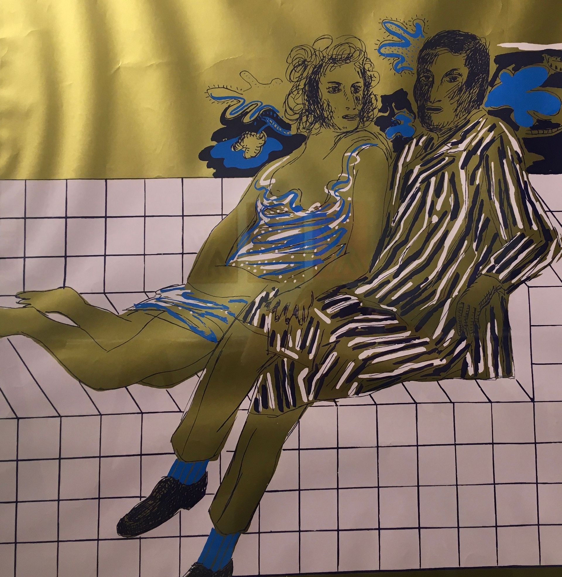 Two figures sit together on a tiled surface against a gold background, with blue stylized floral accents.