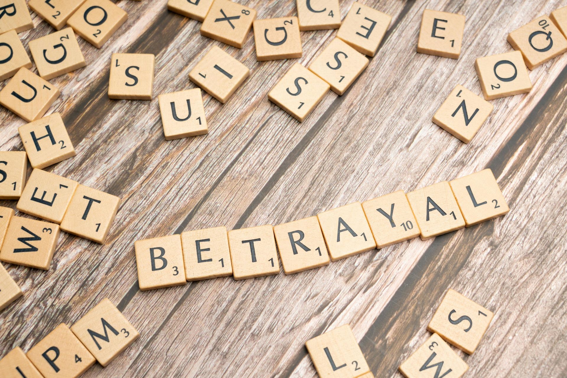 Scrabble tiles on a rustic wooden surface arranged to spell 