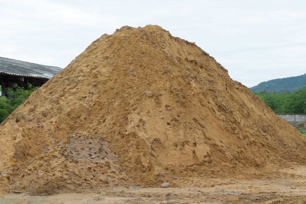 Pile of Tan-colored Sand Against a Cloudy Sky, Likely Outdoors — Australian Sandstone Products In Dalby, QLD