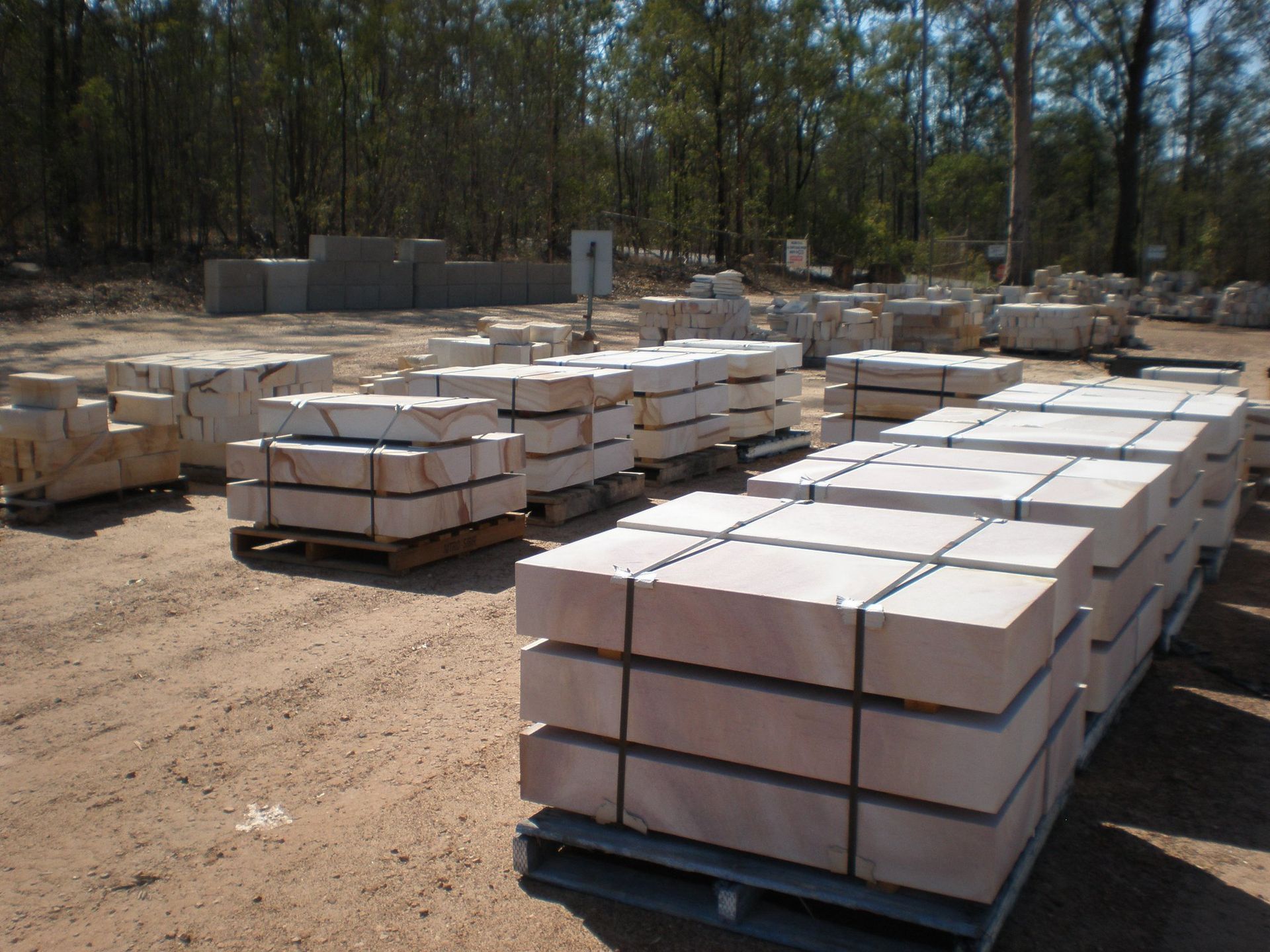 Stacks of Light-colored Stone Blocks on Pallets in an Outdoor Setting — Australian Sandstone Products In Helidon, QLD