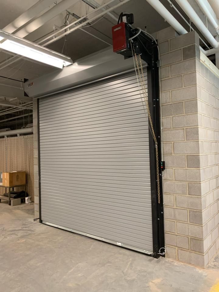 A garage door with a brick wall behind it