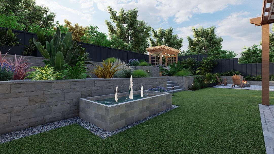 Modern landscaped backyard with stone fountain, retaining wall, lawn, and lush plantings