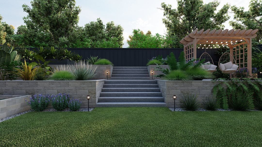 Landscaped garden with central steps, retaining walls, shrubs, trees, and a wooden pergola on the right.