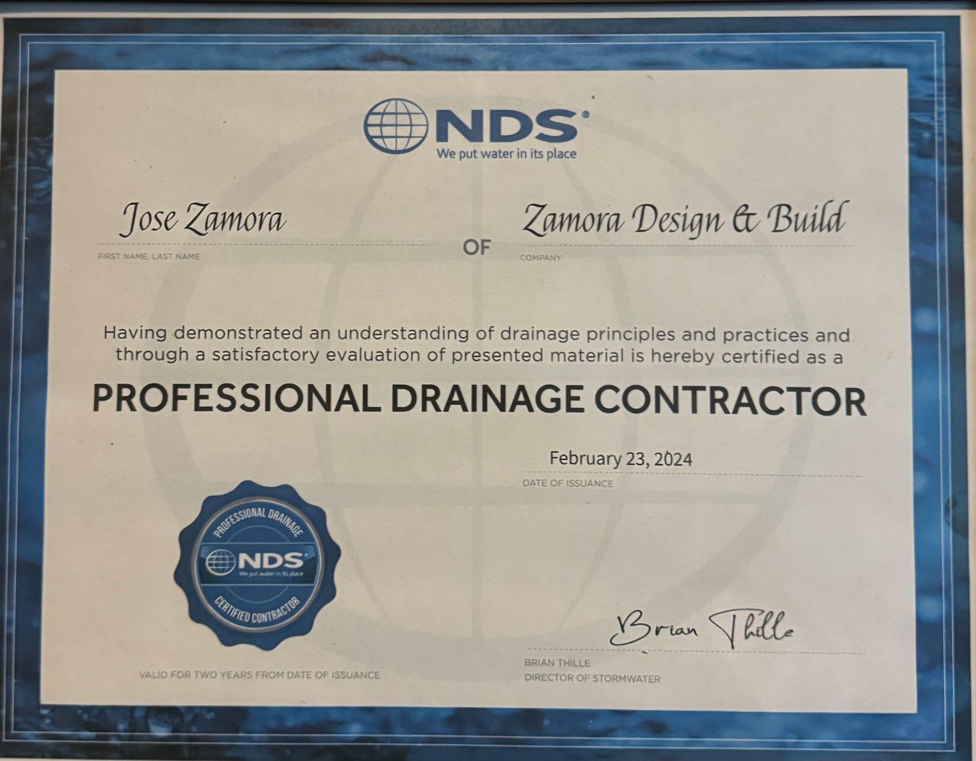 NDS Professional Drainage Contractor certificate in a blue frame with signatures and dated February 21, 2024