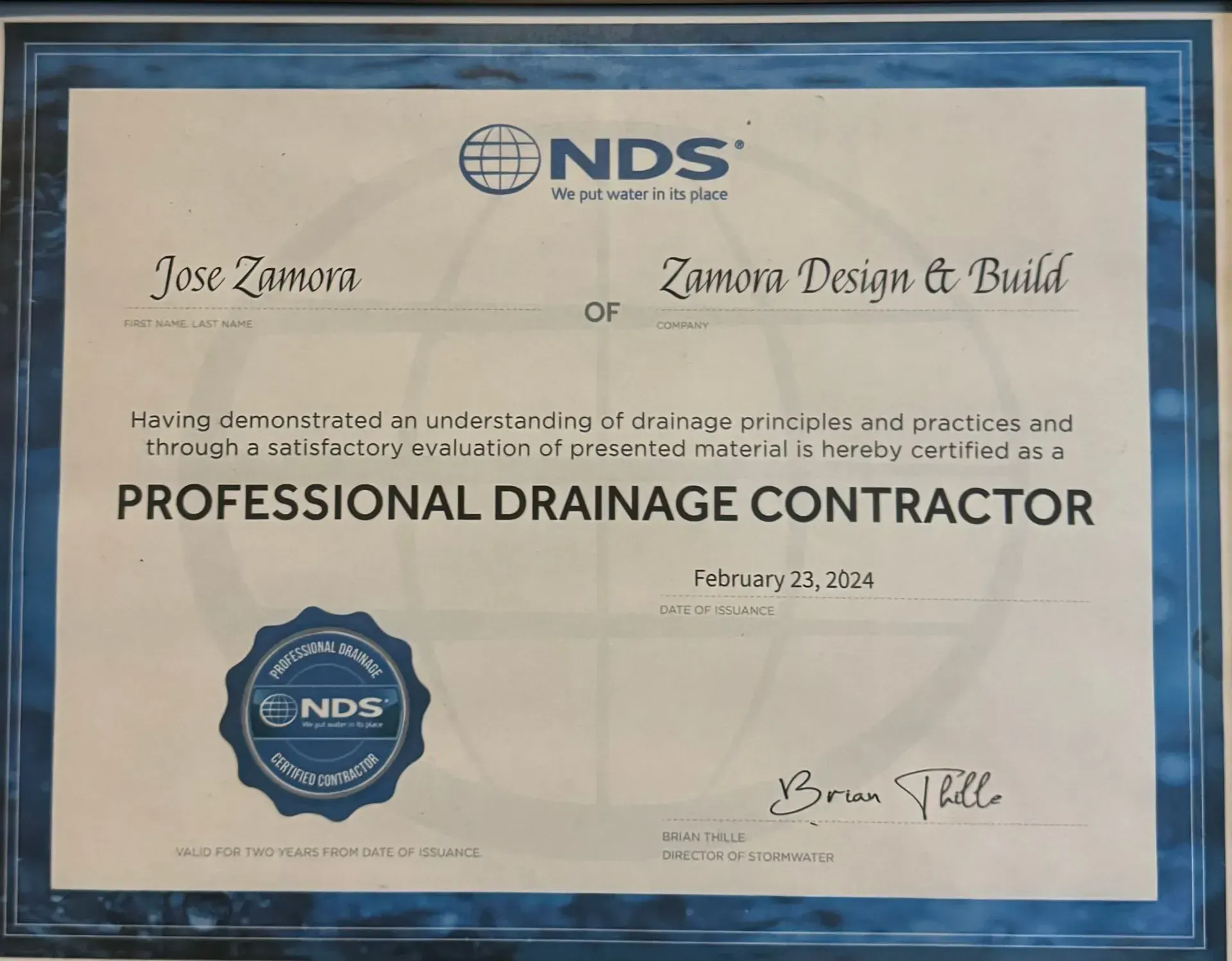 NDS Professional Drainage Contractor certificate on blue background, signed and dated February 27, 2024