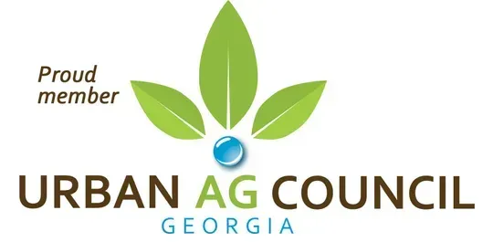 Urban Ag Council Georgia logo with green leaves and blue globe; “Proud member” text above.