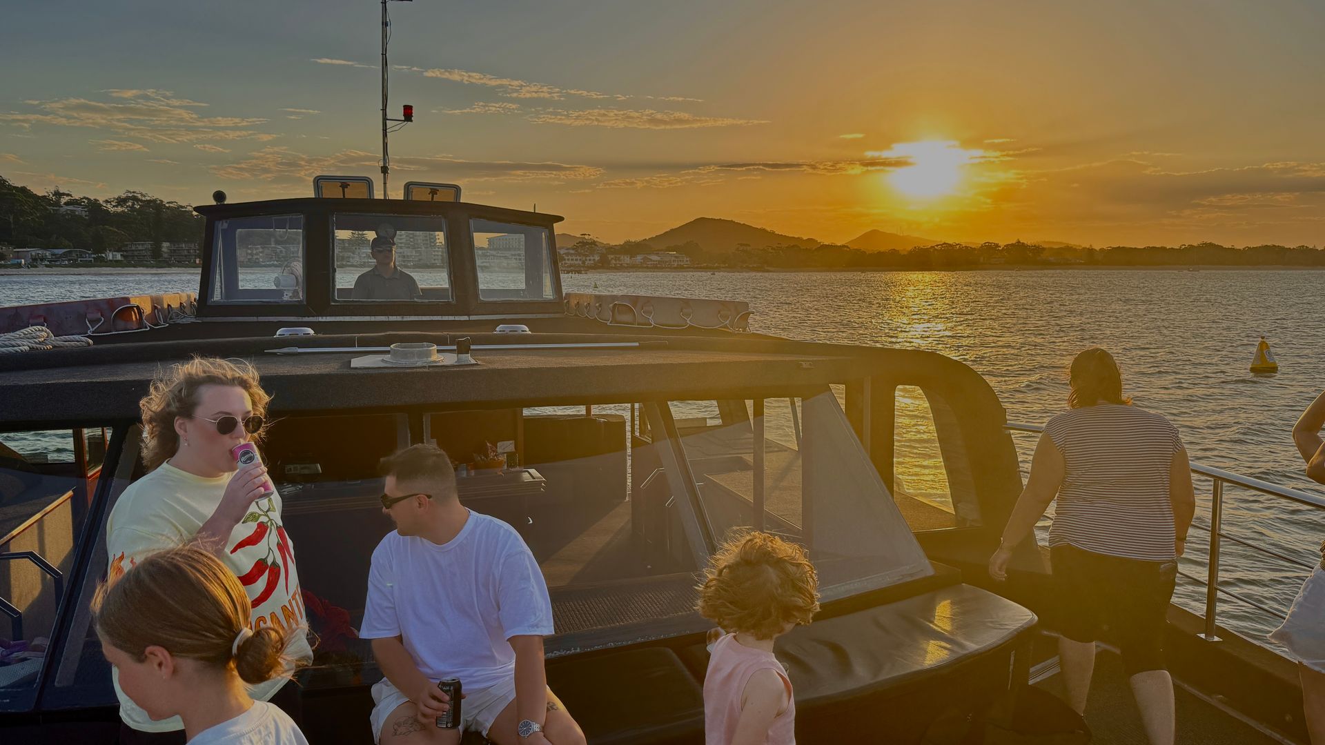 People on A Boat Deck Celebrating with Drinks, Ocean in The Background — YKnot Cruises in Nelson Bay, NSW