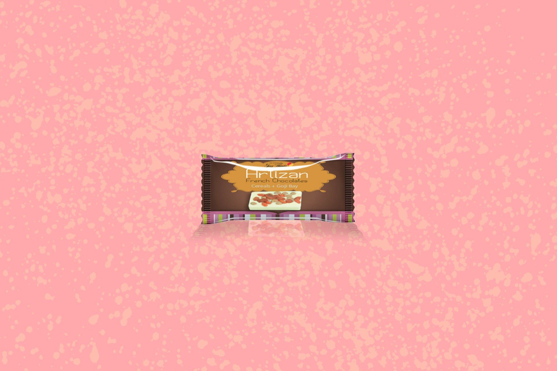Chocolate bar in a wrapper on a pink background. Wrapper is brown with gold lettering.