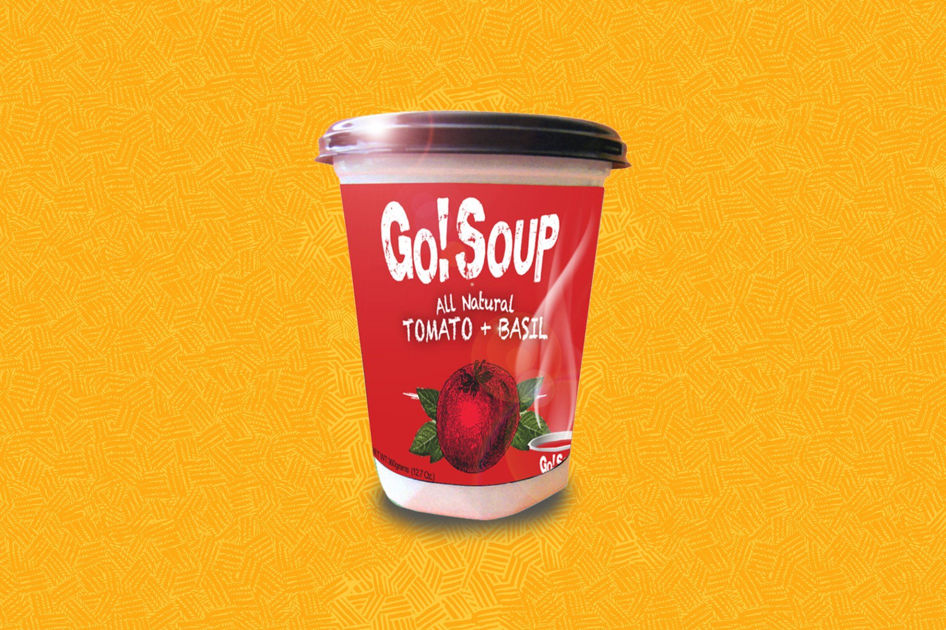 A container of Go! Soup, tomato and basil flavor, against a yellow background.