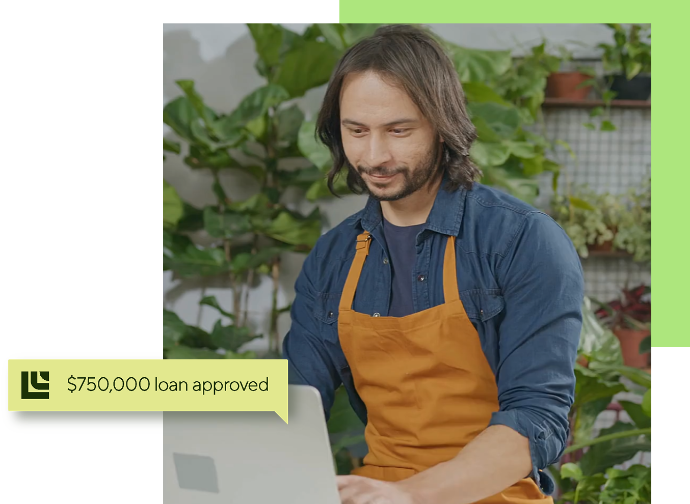 Man in apron using laptop in a plant shop; a notification bubble reads 