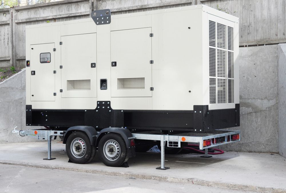 A Generator Is Sitting On A Trailer In A Parking Lot — In Electrics In Mission Beach, QLD