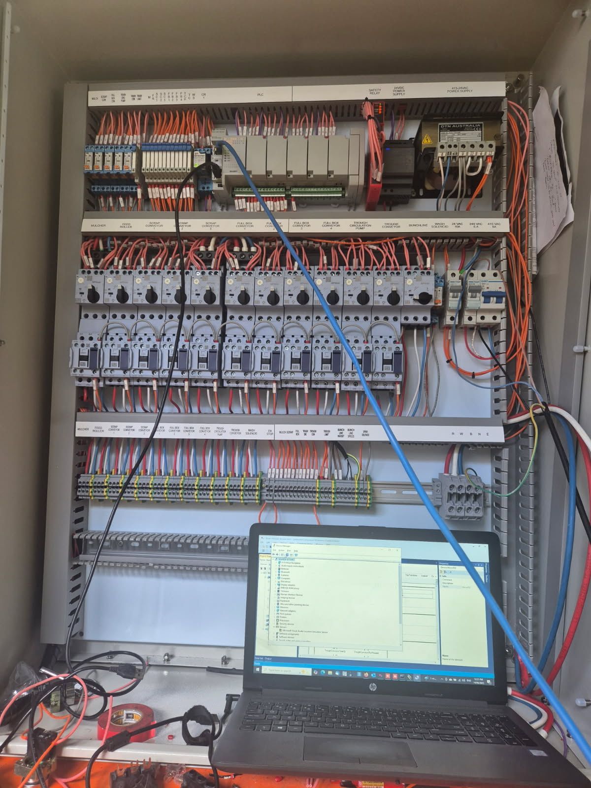 An Electrician Is Working On An Electrical Panel — In Electrics In Innisfail, QLD