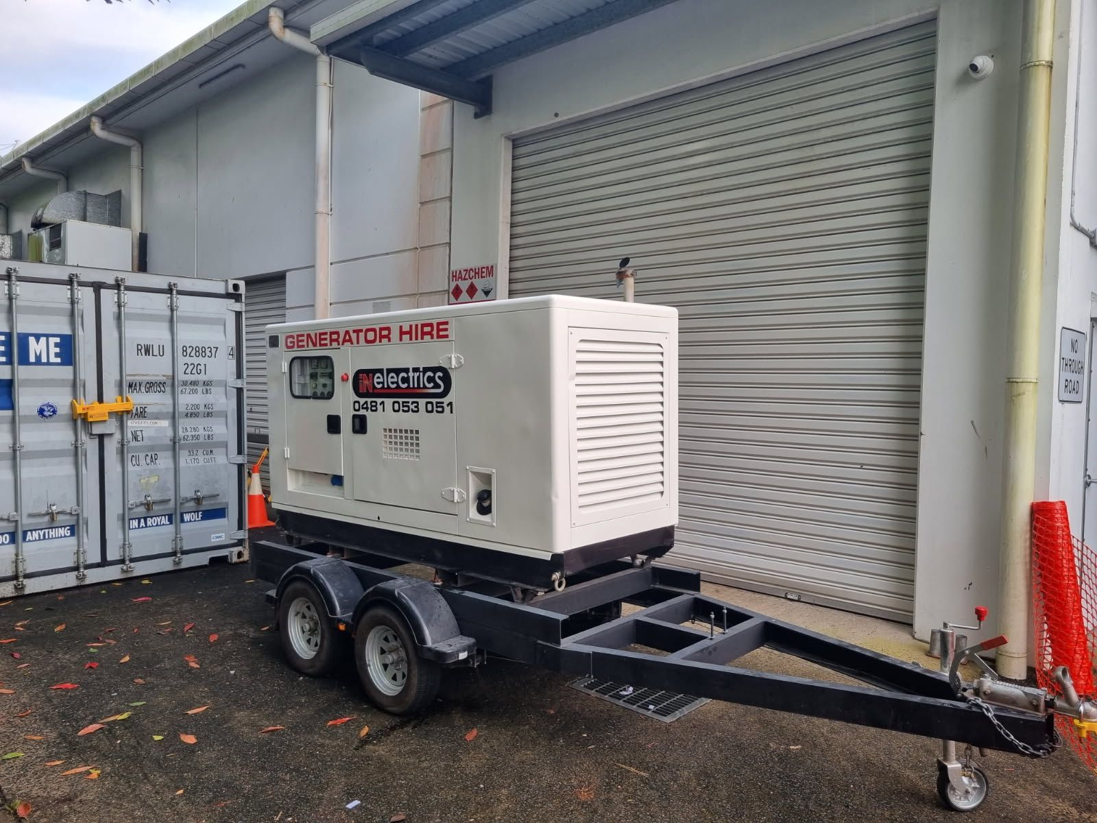 A Yellow Scissor Lift Is Sitting On The Side Of A Building — In Electrics In Innisfail, QLD