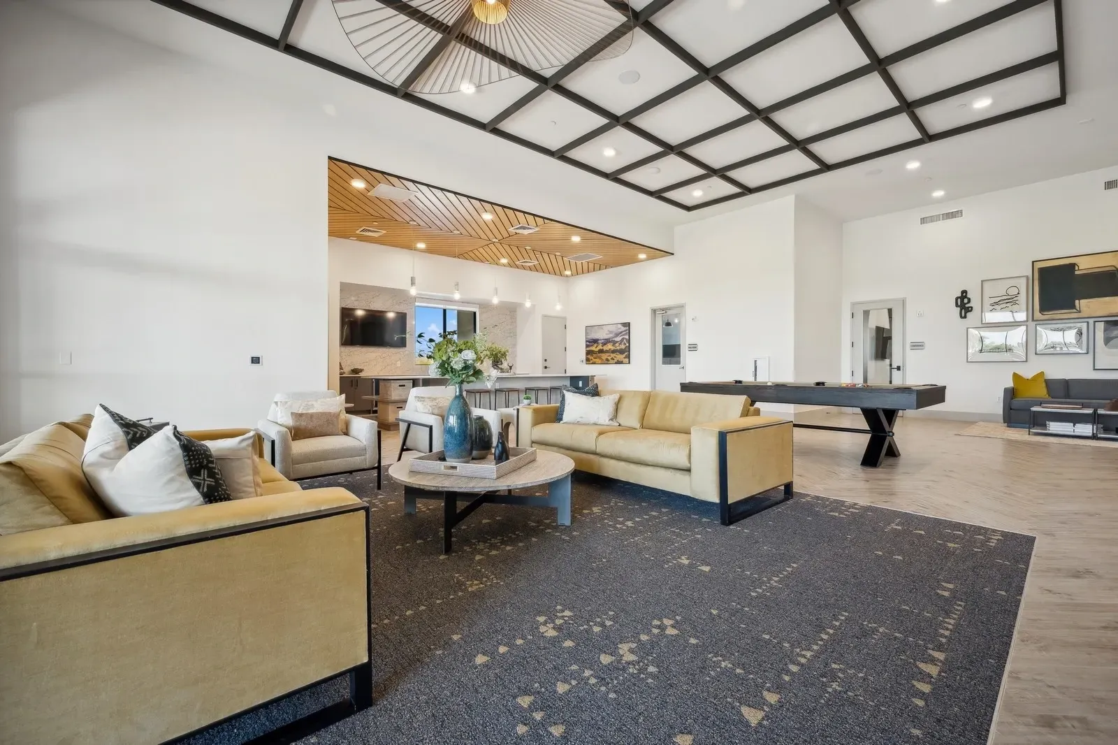 Upscale resident lounge with comfortable seating, a billiards table, and a bar area at Longbow Luxury Apartments Mesa, AZ.