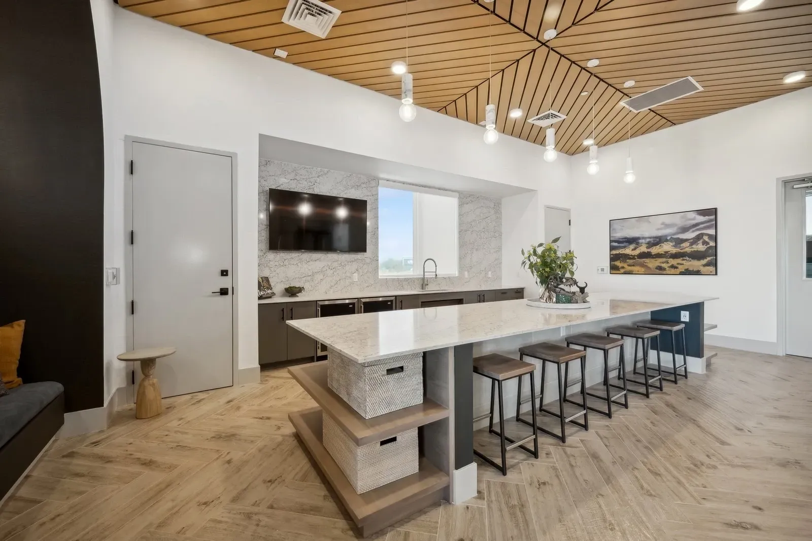 Community lounge area with a kitchen island and bar stools. at Longbow Luxury Apartments Mesa, AZ.