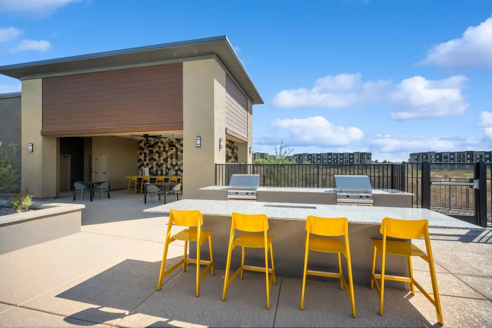 Outdoor grilling area with built-in barbecues and seating at Longbow Luxury Apartments Mesa, AZ.