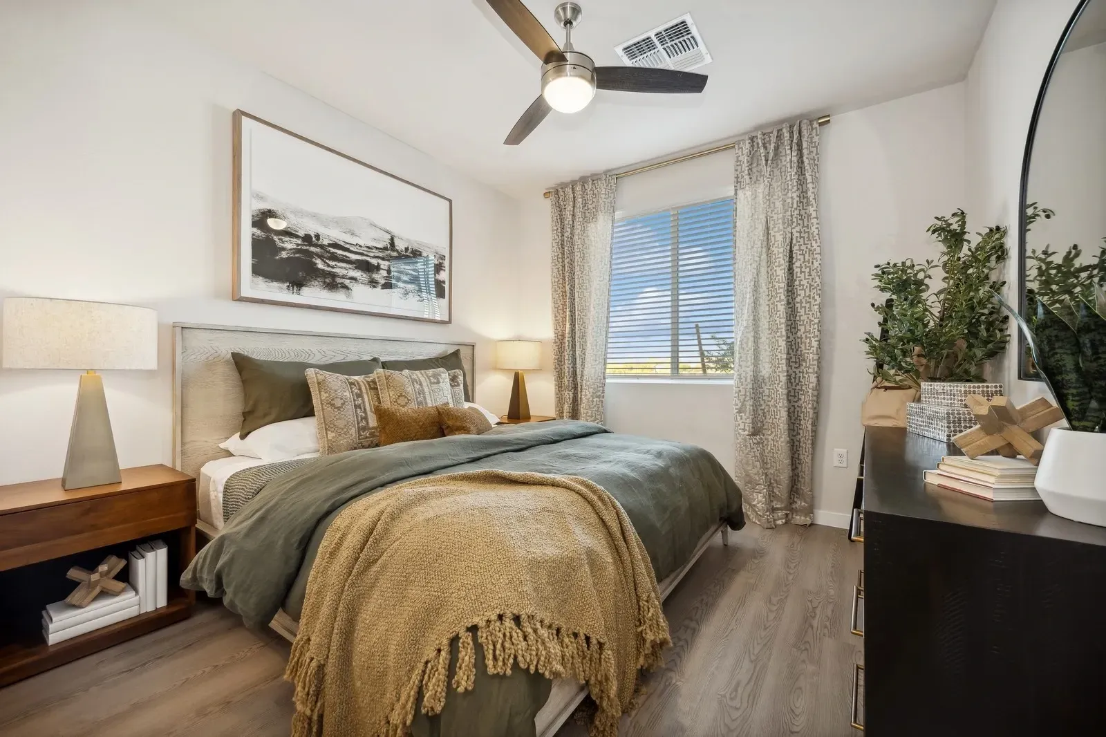 Cozy bedroom with a queen-sized bed, nightstand, and dresser.