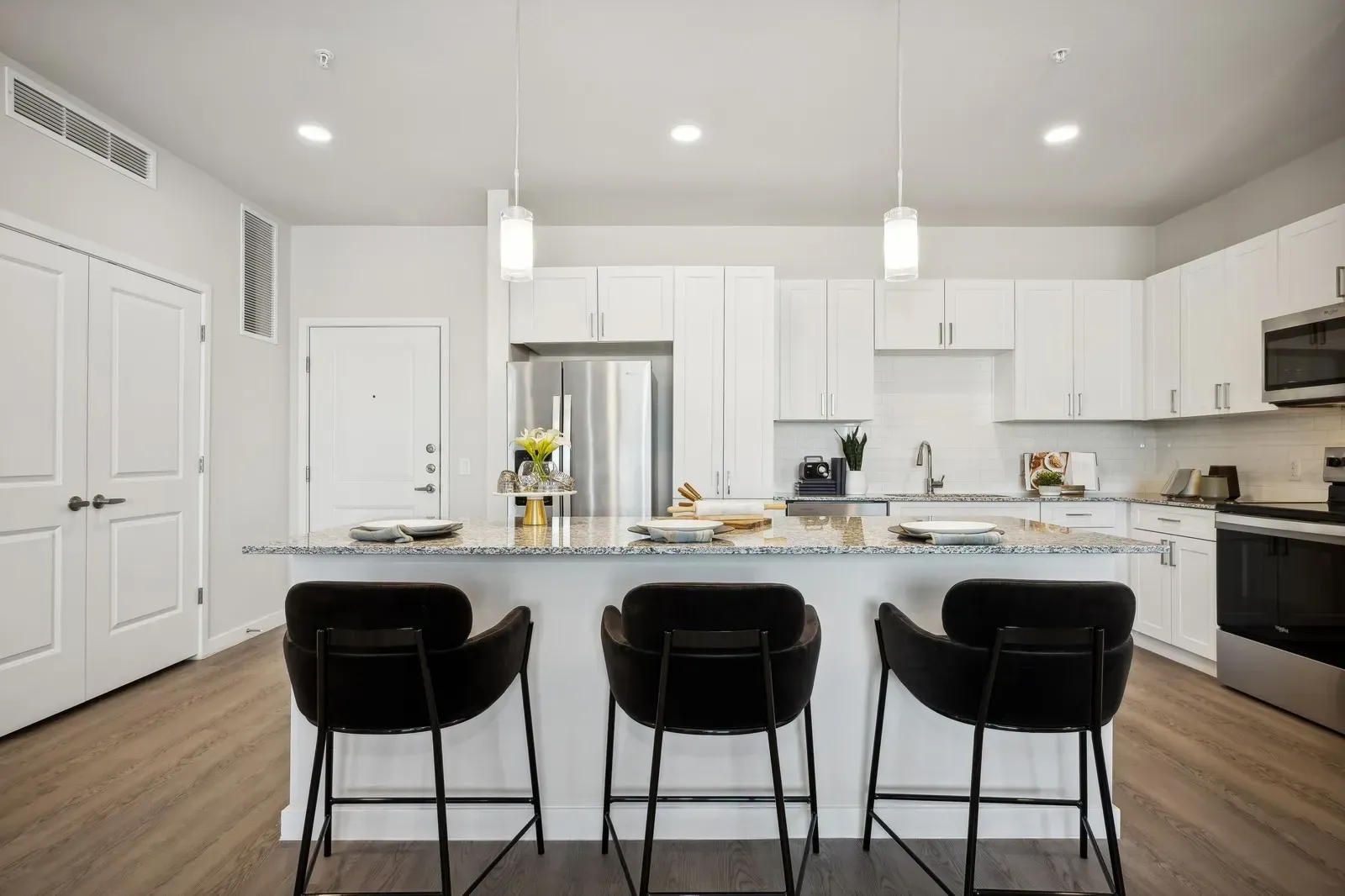 Modern kitchen with island and bar stools.