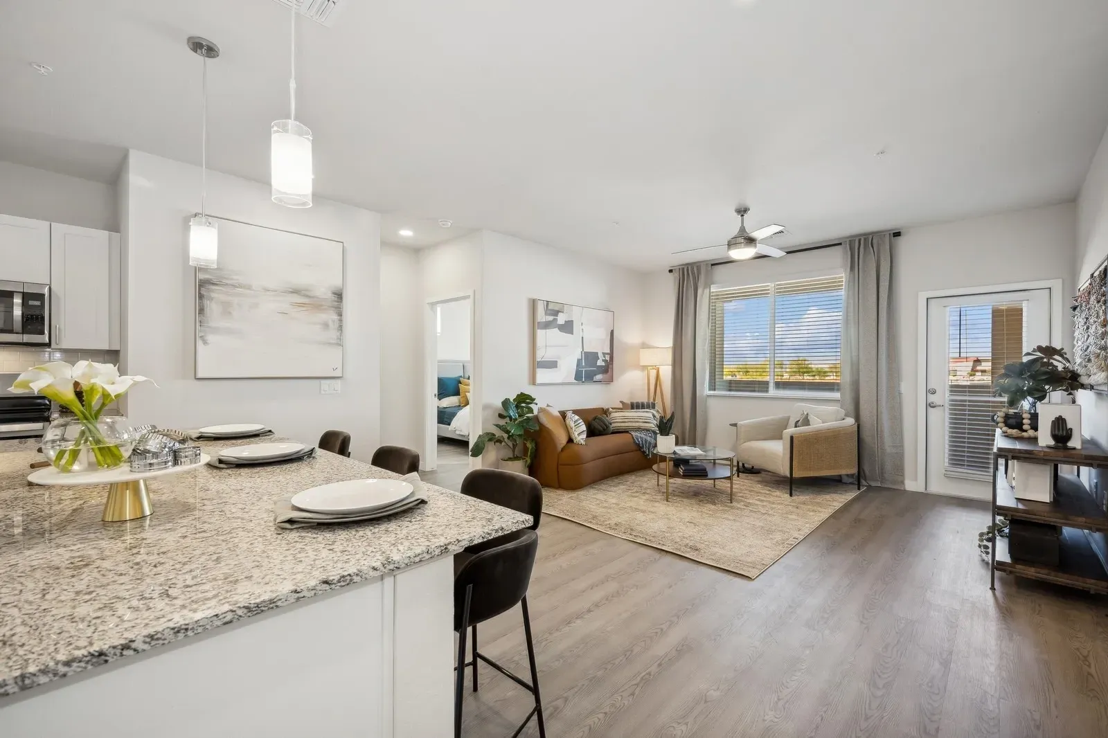 Modern open-concept living area and kitchen with island seating at Longbow Luxury Apartments Mesa, AZ.