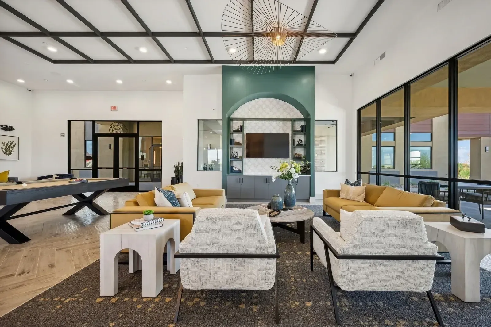 Lounge area with pool table, seating, and entertainment center at Longbow Luxury Apartments in Mesa, AZ