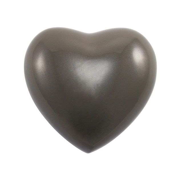 Shiny dark gray heart-shaped object on a white background