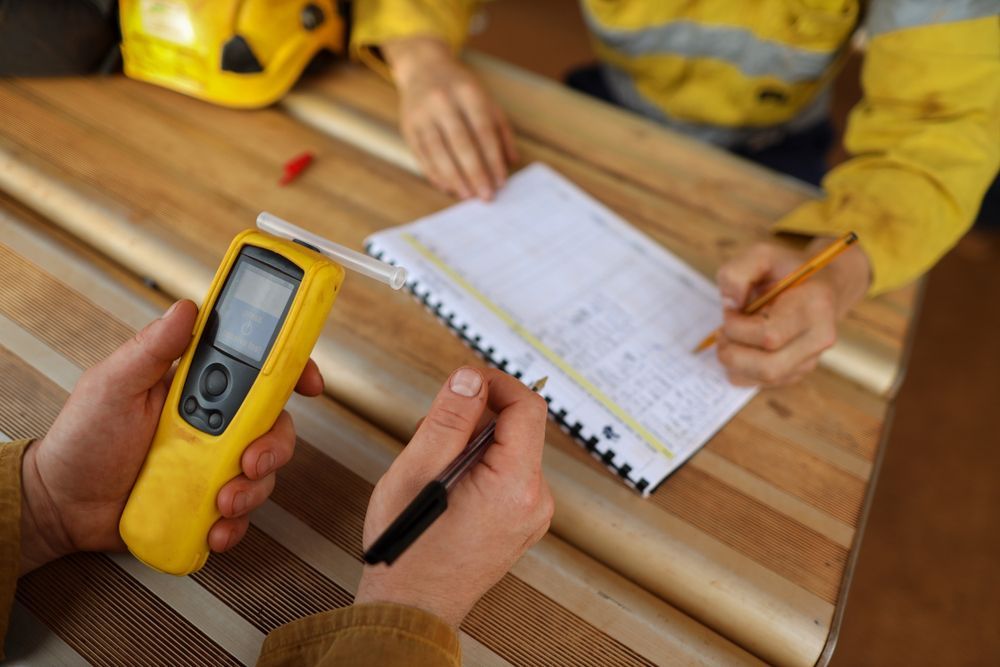 Person Holding a Yellow Gas Detector — DAB Services in Cannonvale, QLD