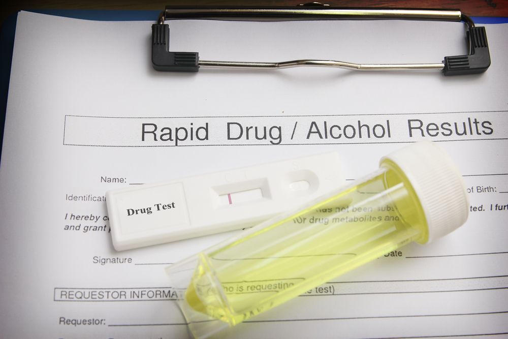 Person in Blue Gloves Filling a Syringe From a Vial With a Clear Liquid — DAB Services in Cannonvale, QLD