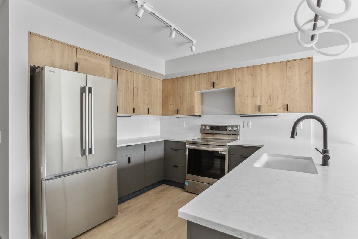 A kitchen with stainless steel appliances and wooden cabinets