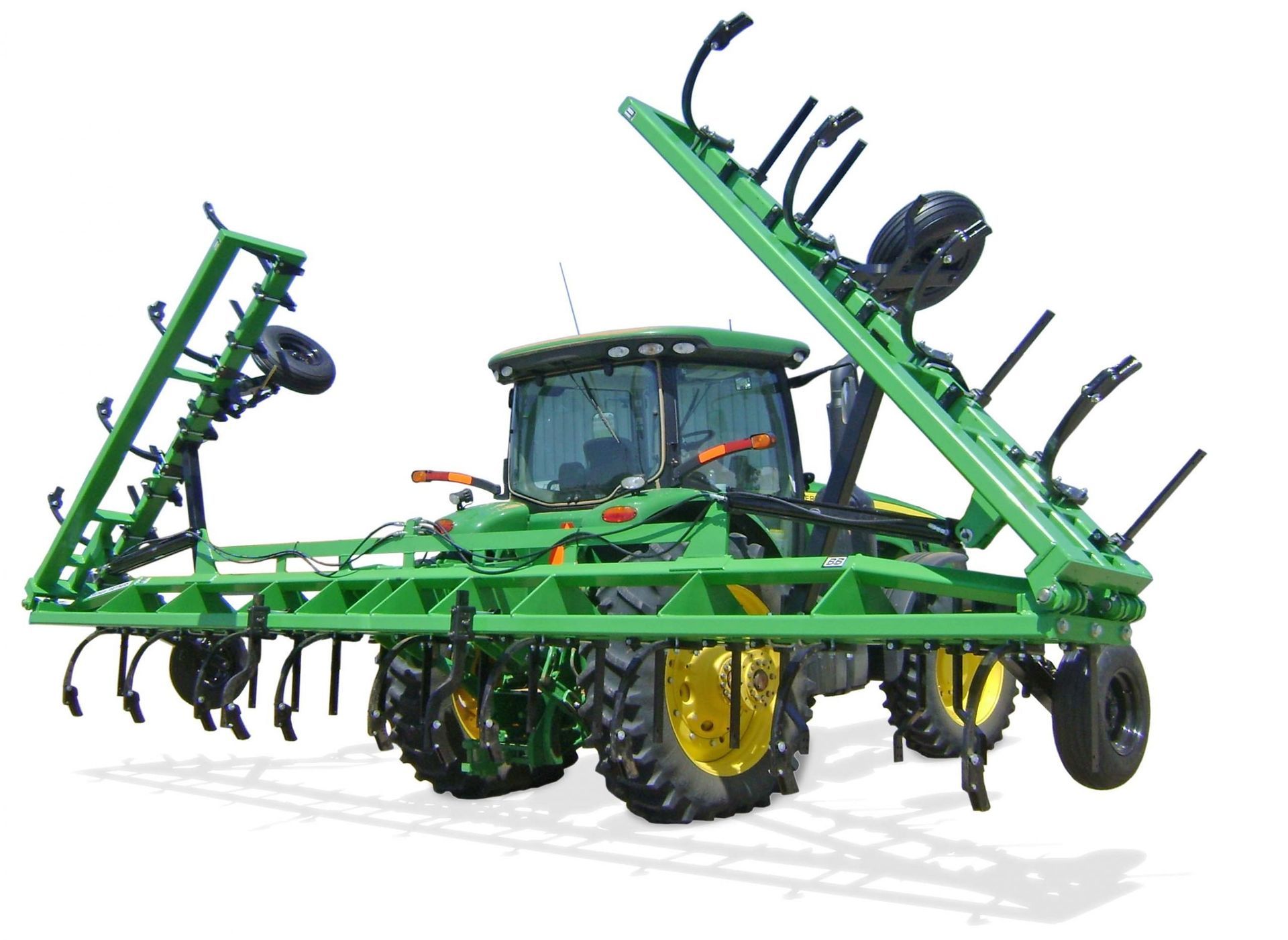 A green john deere tractor with a plow attached to it