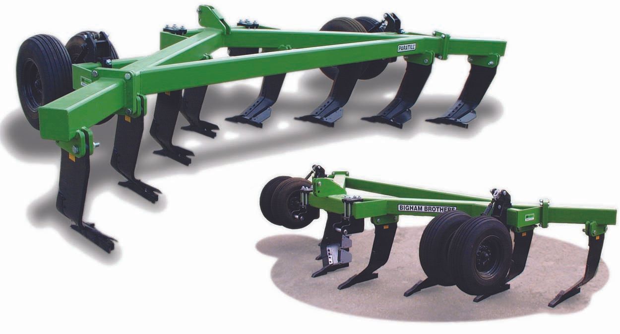 A green and black tractor plow with wheels