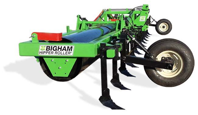 A green and black tractor with the word bigham on the side.
