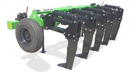 A green and black machine is sitting on a white surface.