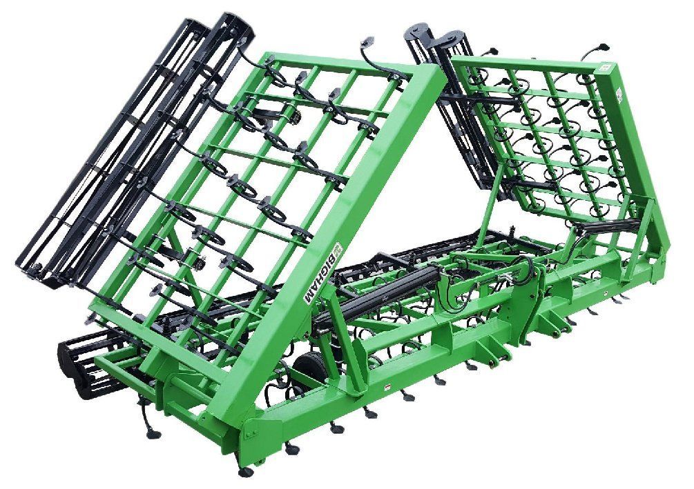A green and black tractor is sitting on top of a white surface.