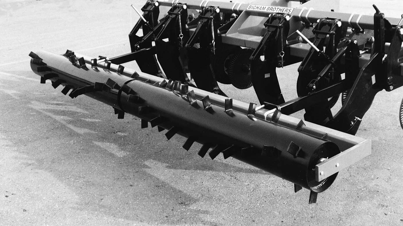 A black and white photo of a tractor on the ground
